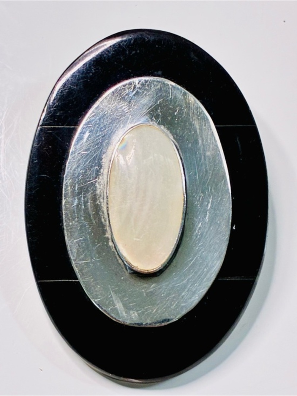 Elevated Simple Black and Silver Oval Brooch with Mother-of-Pearl Center Pendant